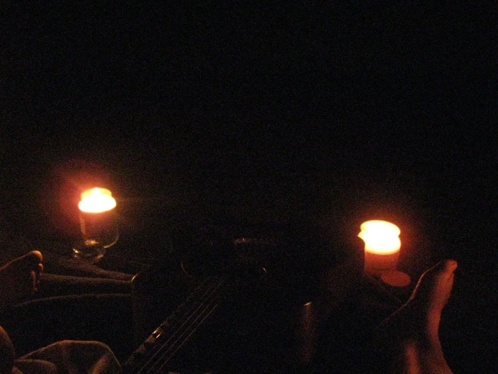 Two candles and a guitar in the dark