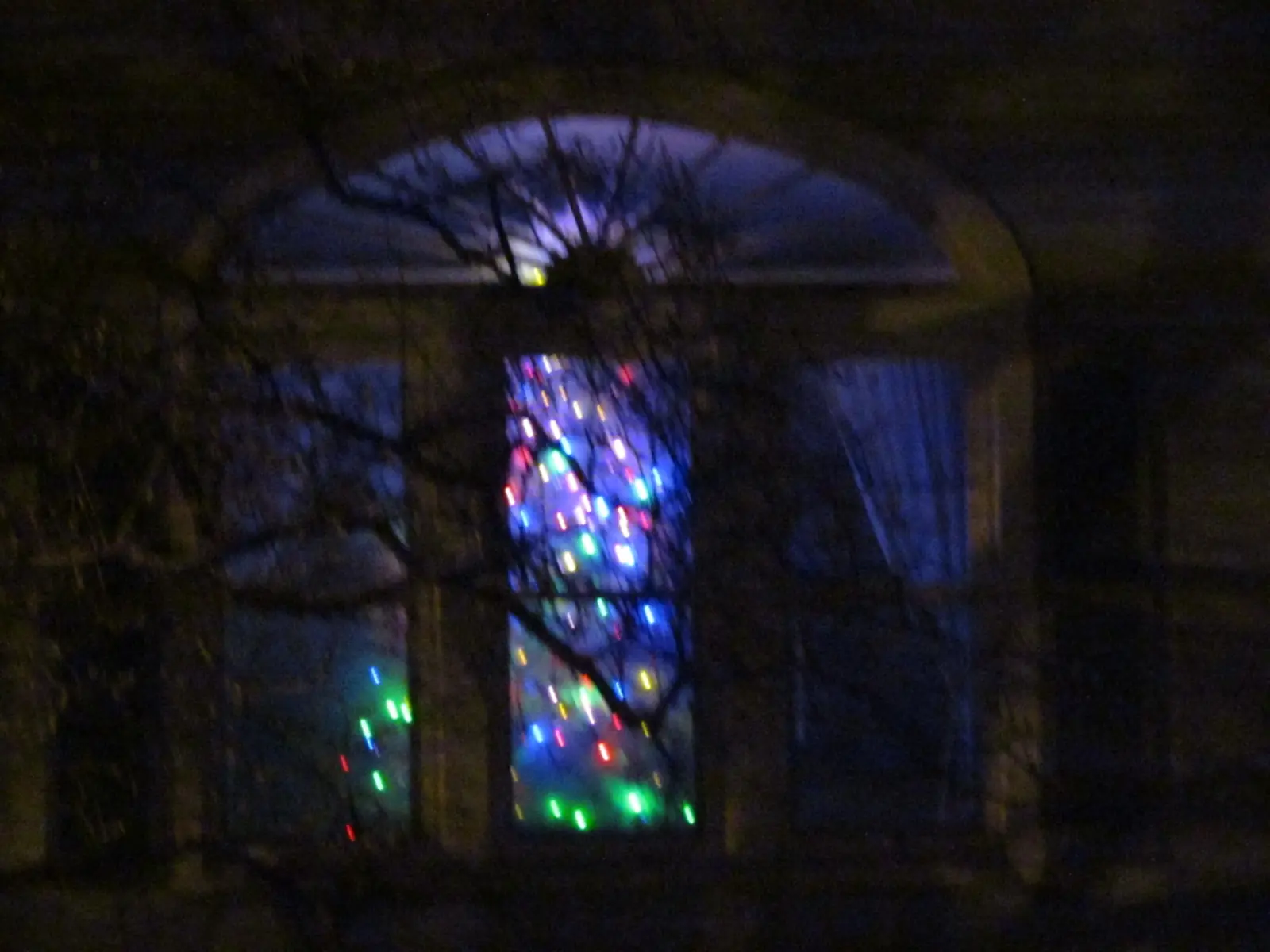 Coloured lights through a window at night